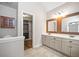 Spacious bathroom featuring dual vanities, large mirrors, and access to the walk-in closet at 505 Summer Ter, Woodstock, GA 30189