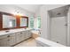 Bathroom with dual vanities, large soaking tub, and separate stand up shower, offering space and modern elegance at 505 Summer Ter, Woodstock, GA 30189