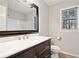 Bright bathroom with a dark wooden vanity and a large mirror at 505 Summer Ter, Woodstock, GA 30189