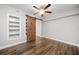 Bedroom with hardwood floors, a ceiling fan, shelving and sliding barn door at 505 Summer Ter, Woodstock, GA 30189