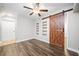 Bedroom with new hardwood floors, a ceiling fan, shelving and sliding barn door at 505 Summer Ter, Woodstock, GA 30189