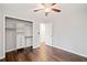 Bedroom with hardwood floors, closet, ceiling fan, and doorway to another room at 505 Summer Ter, Woodstock, GA 30189