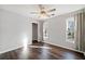 Sunlit bedroom with hardwood floors, ceiling fan, neutral paint, and closet access at 505 Summer Ter, Woodstock, GA 30189