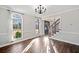 Inviting dining room featuring hardwood floors, arched windows, and a stylish chandelier at 505 Summer Ter, Woodstock, GA 30189