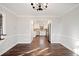 Open dining area view with hardwood floors and a glimpse of the modern kitchen at 505 Summer Ter, Woodstock, GA 30189