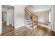 Modern foyer with hardwood floors, an elegant staircase, and an open view into the adjacent living spaces at 505 Summer Ter, Woodstock, GA 30189