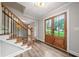 Elegant entryway featuring wood flooring, a staircase with iron railings, and a view of the living spaces at 505 Summer Ter, Woodstock, GA 30189