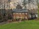 Charming brick home featuring blue shutters and a well-maintained green front yard surrounded by mature trees at 505 Summer Ter, Woodstock, GA 30189