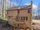 Back exterior elevation of the house featuring a deck and stairs at 505 Summer Ter, Woodstock, GA 30189