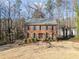 Two-story brick home with blue shutters and a spacious front lawn surrounded by trees at 505 Summer Ter, Woodstock, GA 30189