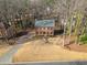 Aerial view of a brick home with a well-maintained lawn and a long driveway at 505 Summer Ter, Woodstock, GA 30189