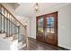 Inviting foyer with hardwood floors, staircase, and an elegant double-door entrance at 505 Summer Ter, Woodstock, GA 30189