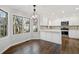 Updated kitchen features white cabinetry, hardwood floors, stainless steel appliances, and natural light at 505 Summer Ter, Woodstock, GA 30189