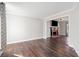 Cozy living room featuring hardwood floors, a brick fireplace, and ample natural light at 505 Summer Ter, Woodstock, GA 30189