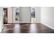 Living room boasts hardwood flooring and two large windows that bring in tons of natural light at 505 Summer Ter, Woodstock, GA 30189
