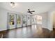 Open floor plan with fireplace, ceiling fan, wood floors, and lots of natural light at 505 Summer Ter, Woodstock, GA 30189