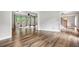 Spacious open-concept living area with hardwood floors, large windows, and a smooth transition into adjacent rooms at 505 Summer Ter, Woodstock, GA 30189