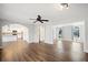 Spacious living room with dark wood floors, ceiling fan, and views to the kitchen and sunroom at 505 Summer Ter, Woodstock, GA 30189