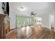 Open floor plan with fireplace, ceiling fan, wood floors, and lots of natural light at 505 Summer Ter, Woodstock, GA 30189