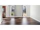 Bright living room features dark wood floors, fresh neutral paint, and arched windows with decorative curtains at 505 Summer Ter, Woodstock, GA 30189