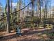 A backyard playground with a swing set, slide, and treehouse at 505 Summer Ter, Woodstock, GA 30189