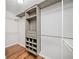 Organized walk-in closet with custom shelving, drawers, and hanging rods for efficient storage at 505 Summer Ter, Woodstock, GA 30189