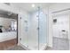 Modern bathroom featuring a glass-enclosed shower and patterned tile floors, adjacent to the main bedroom at 260 18Th Nw St # 10202, Atlanta, GA 30363