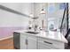 Bright kitchen island features stainless steel appliances, quartz countertops, and a copper faucet for an elevated look at 260 18Th Nw St # 10202, Atlanta, GA 30363