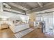 Luxurious main bedroom featuring exposed ceilings, modern decor, and a comfortable sitting area with lots of light at 260 18Th Nw St # 10202, Atlanta, GA 30363