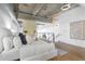 Bright and airy main bedroom with exposed ceilings and ductwork, a bed with white linens and hardwood floors at 260 18Th Nw St # 10202, Atlanta, GA 30363