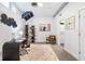 Modern office space with unique decor, a stylish desk, a bookshelf, and a comfortable chair on patterned carpet at 260 18Th Nw St # 10202, Atlanta, GA 30363