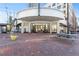Retail store front featuring a circular entrance, brick sidewalk, and picnic table seating in a pedestrian-friendly area at 260 18Th Nw St # 10202, Atlanta, GA 30363