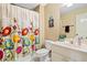 Charming bathroom with colorful floral shower curtain and ample counter space at 404 N Cascades Cir, Canton, GA 30114