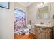 Charming bathroom with decorative shower curtain, vanity and wood look flooring at 404 N Cascades Cir, Canton, GA 30114
