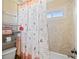 Cozy bathroom featuring a floral shower curtain and tiled walls at 404 N Cascades Cir, Canton, GA 30114