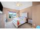 Charming bedroom with a floral bedspread, tray ceiling, and natural light at 404 N Cascades Cir, Canton, GA 30114