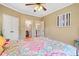 Bright bedroom with a colorful quilt, ceiling fan, and 'Love' wall decor at 404 N Cascades Cir, Canton, GA 30114