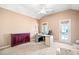 Cozy bedroom with vaulted ceilings, a desk, and a door leading to a private balcony at 404 N Cascades Cir, Canton, GA 30114