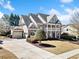 Elegant two-story home with a brick facade, attached garage, and well-maintained landscaping at 404 N Cascades Cir, Canton, GA 30114