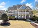 Inviting two-story house with a lovely porch, manicured lawn, and charming curb appeal at 404 N Cascades Cir, Canton, GA 30114