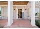 Welcoming front porch with brick flooring, columns, and an open front door at 404 N Cascades Cir, Canton, GA 30114