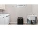 Functional laundry area featuring a washer, dryer, sink, and mini-fridge for added convenience at 404 N Cascades Cir, Canton, GA 30114