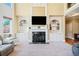 Open-concept living room with fireplace, built-ins, and large windows at 404 N Cascades Cir, Canton, GA 30114