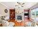Cozy living room with stone fireplace, ceiling fan, and built-in shelving at 404 N Cascades Cir, Canton, GA 30114