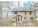 Exterior view of the home featuring backyard with patio, and view of upper windows at 445 Skif Pond Ct, Atlanta, GA 30349