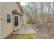 Backyard patio area is accessible from the home, and leads to a wooded area at 445 Skif Pond Ct, Atlanta, GA 30349