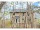 Backyard exterior view of the house featuring rear windows, siding, and access to patio at 445 Skif Pond Ct, Atlanta, GA 30349