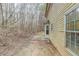 Backyard view of the house and patio, with a wooded area in the background at 445 Skif Pond Ct, Atlanta, GA 30349