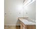 Bathroom features a sink with vanity and large mirror with lights, offering comfort and functionality at 445 Skif Pond Ct, Atlanta, GA 30349