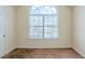 Modest bedroom with a large window and neutral carpet, ready for personalization at 445 Skif Pond Ct, Atlanta, GA 30349